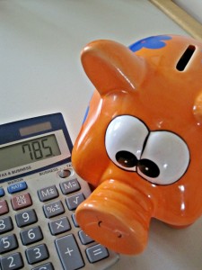 orange piggy bank and calculator